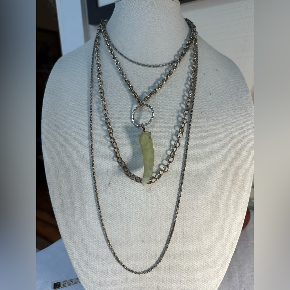 Silvertone multi chain necklace with light green horn dangle